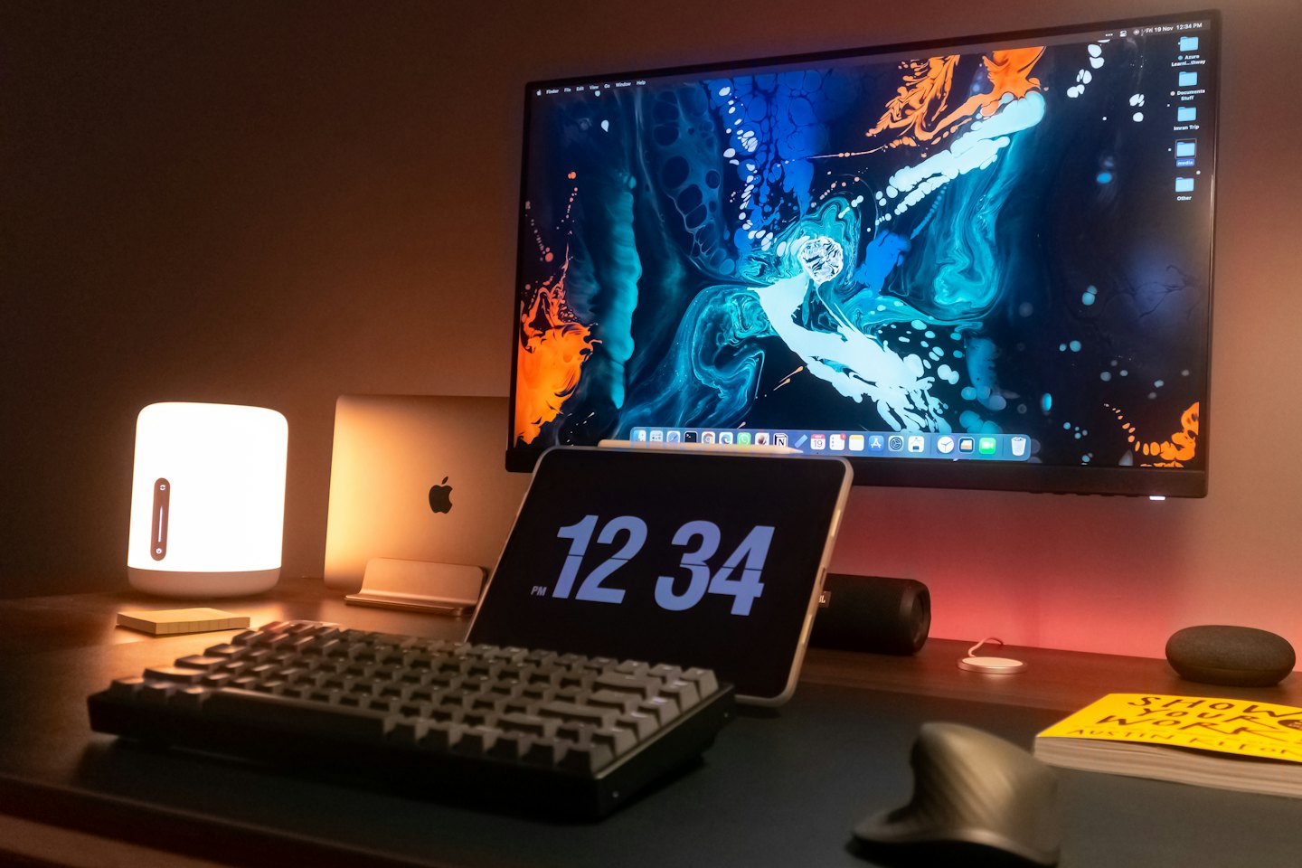 Modern computer equipment arranged on a wooden office desk.